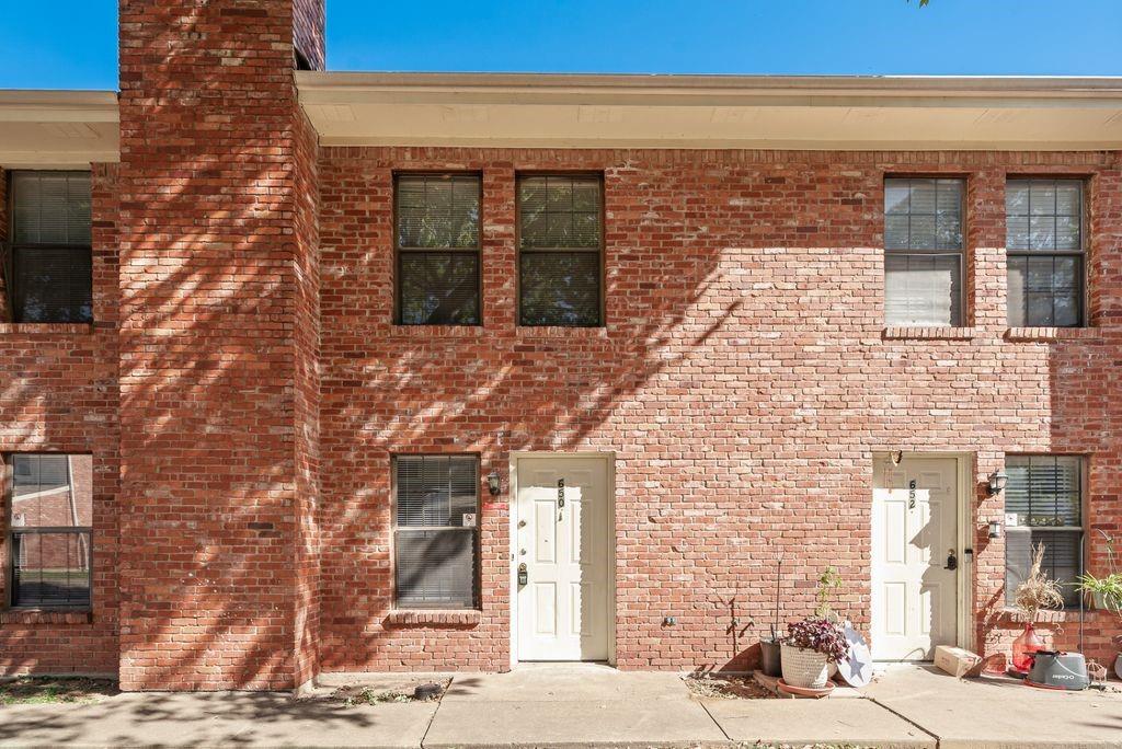 648 South Rogers Road, Unit 650 Irving, TX 75060 - Photo 2 of 21 a brick building with a street
