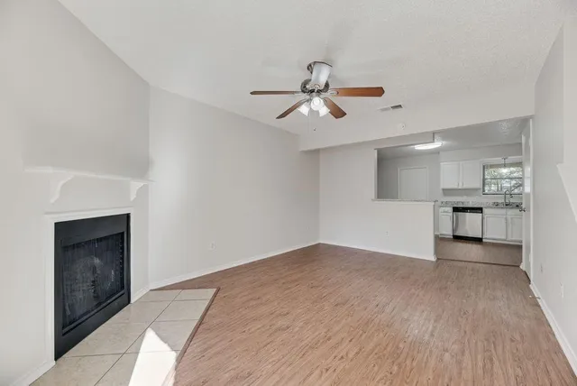 a view of empty room with wooden floor and fireplace