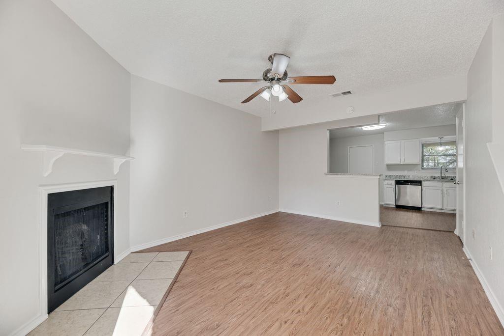 648 South Rogers Road, Unit 650 Irving, TX 75060 - Photo 5 of 21 a view of empty room with wooden floor and fireplace