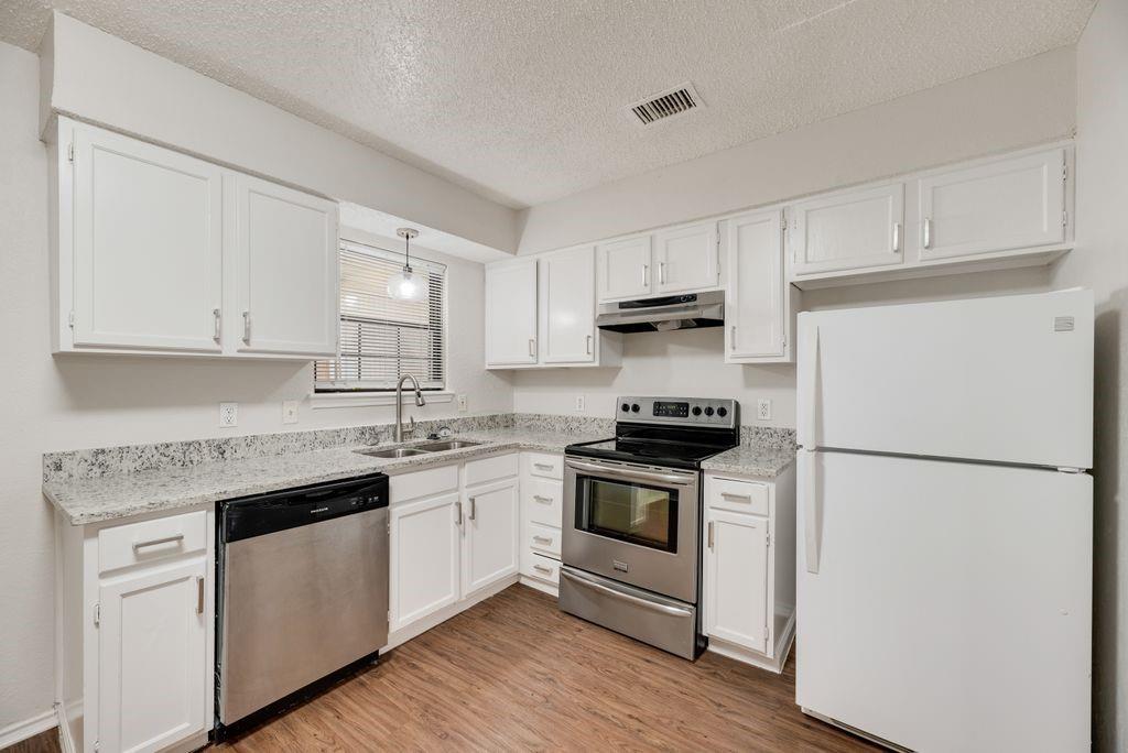 648 South Rogers Road, Unit 650 Irving, TX 75060 - Photo 9 of 21 a kitchen with cabinets appliances a sink and a window