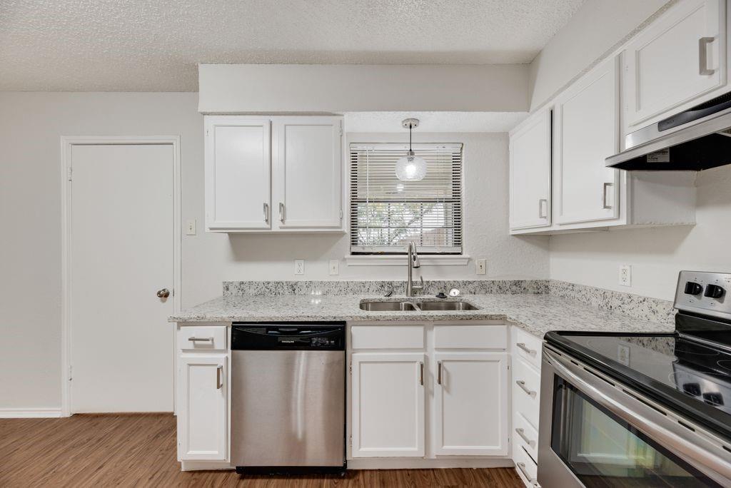 648 South Rogers Road, Unit 650 Irving, TX 75060 - Photo 10 of 21 a kitchen with stainless steel appliances granite countertop a sink stove and cabinets