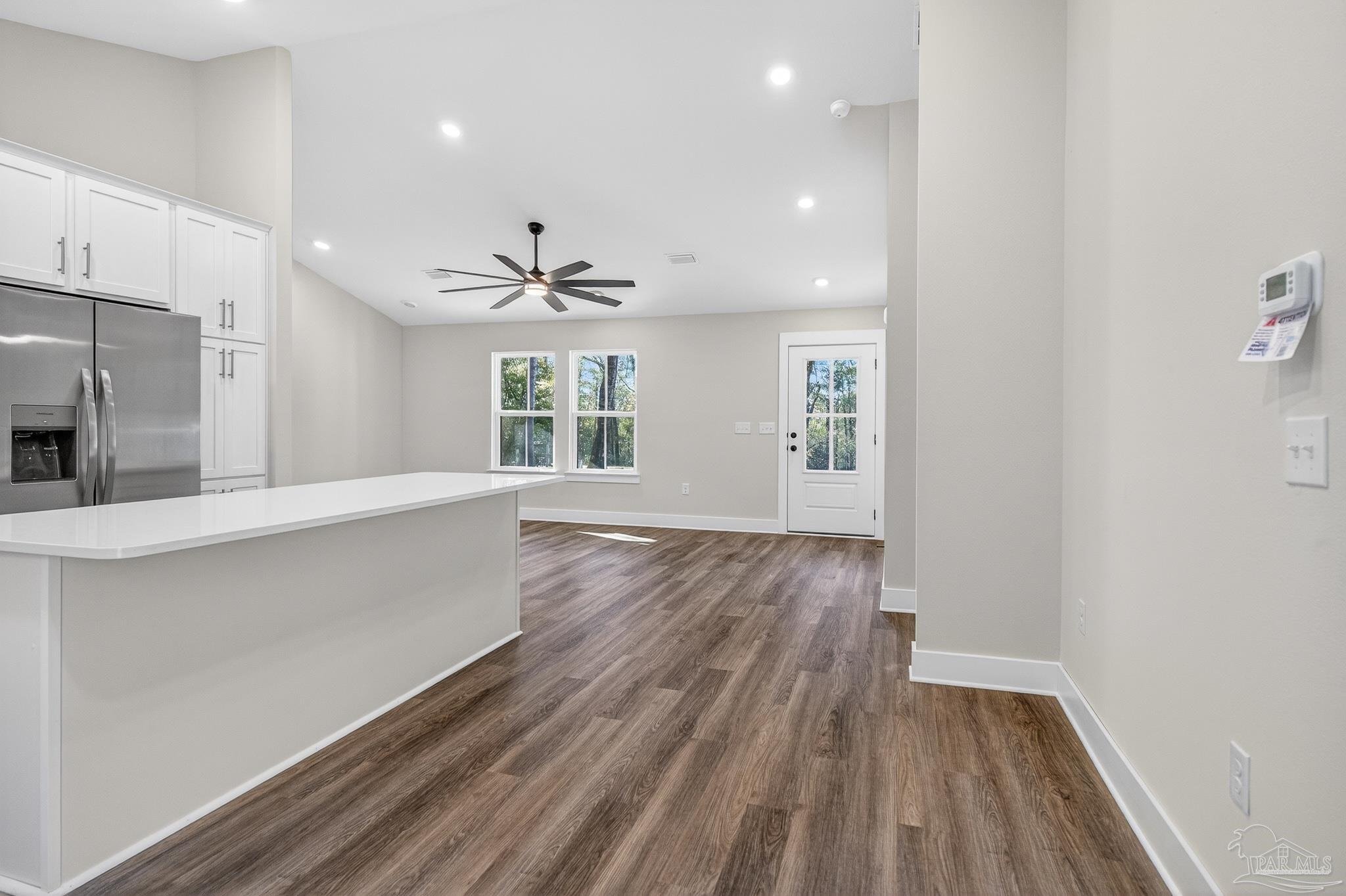 1056 Barth Road Molino, FL 32577 - Photo 12 of 46 a view of an empty room with wooden floor and a window