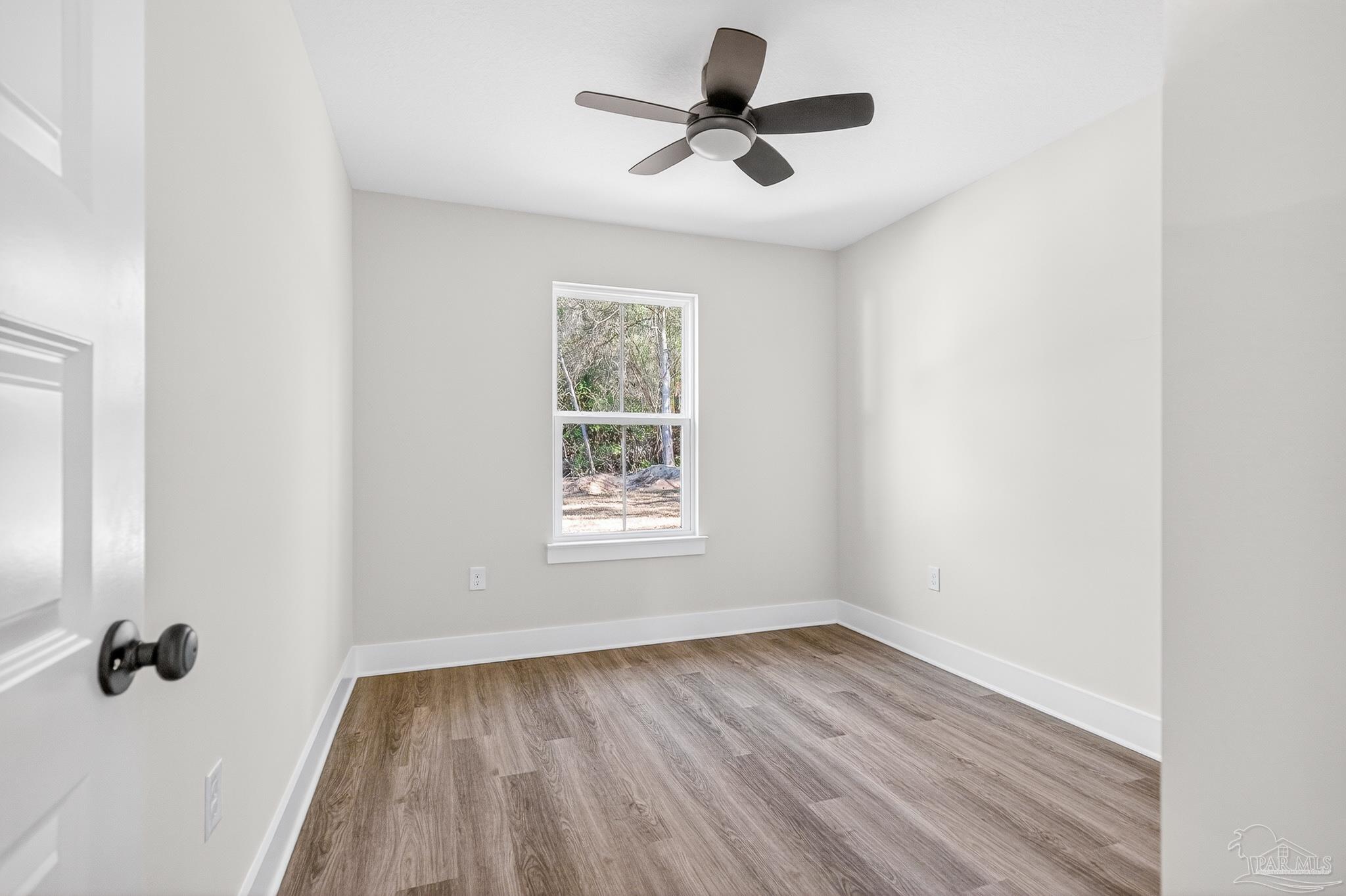 1056 Barth Road Molino, FL 32577 - Photo 13 of 46 an empty room with a window and a ceiling fan