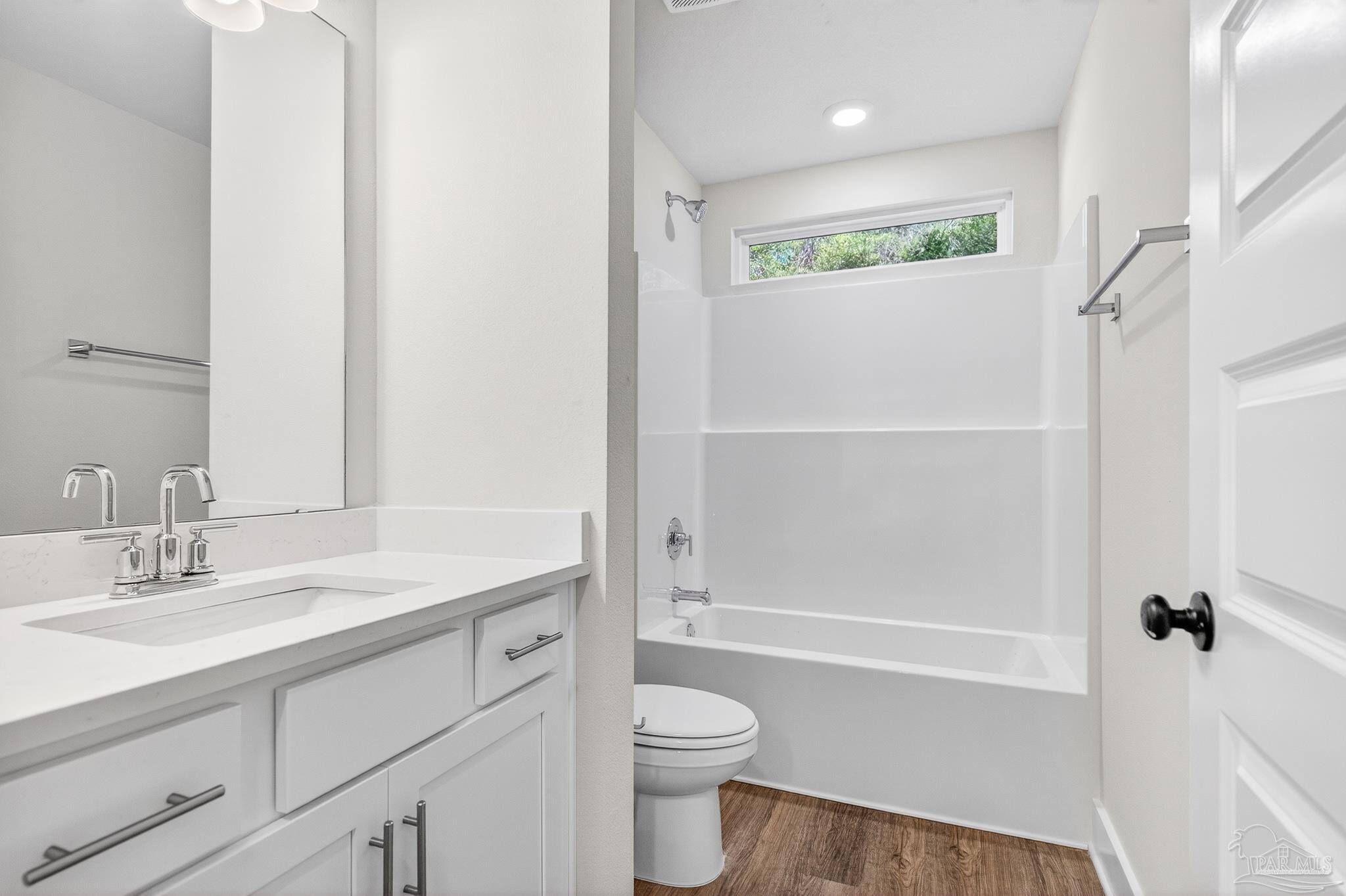 1056 Barth Road Molino, FL 32577 - Photo 15 of 46 a bathroom with a granite countertop sink a toilet and shower