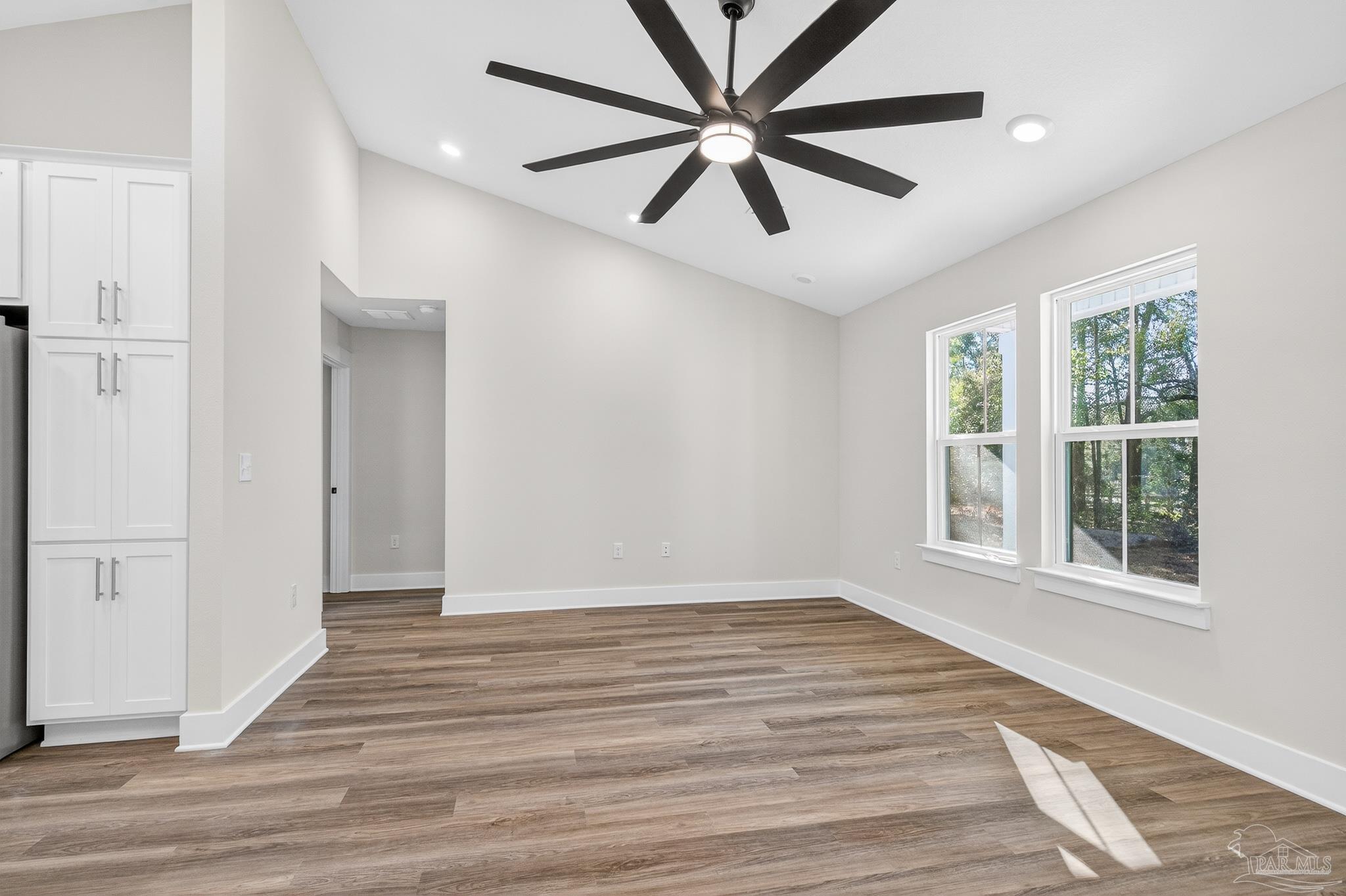 1056 Barth Road Molino, FL 32577 - Photo 17 of 46 an empty room with wooden floor and windows