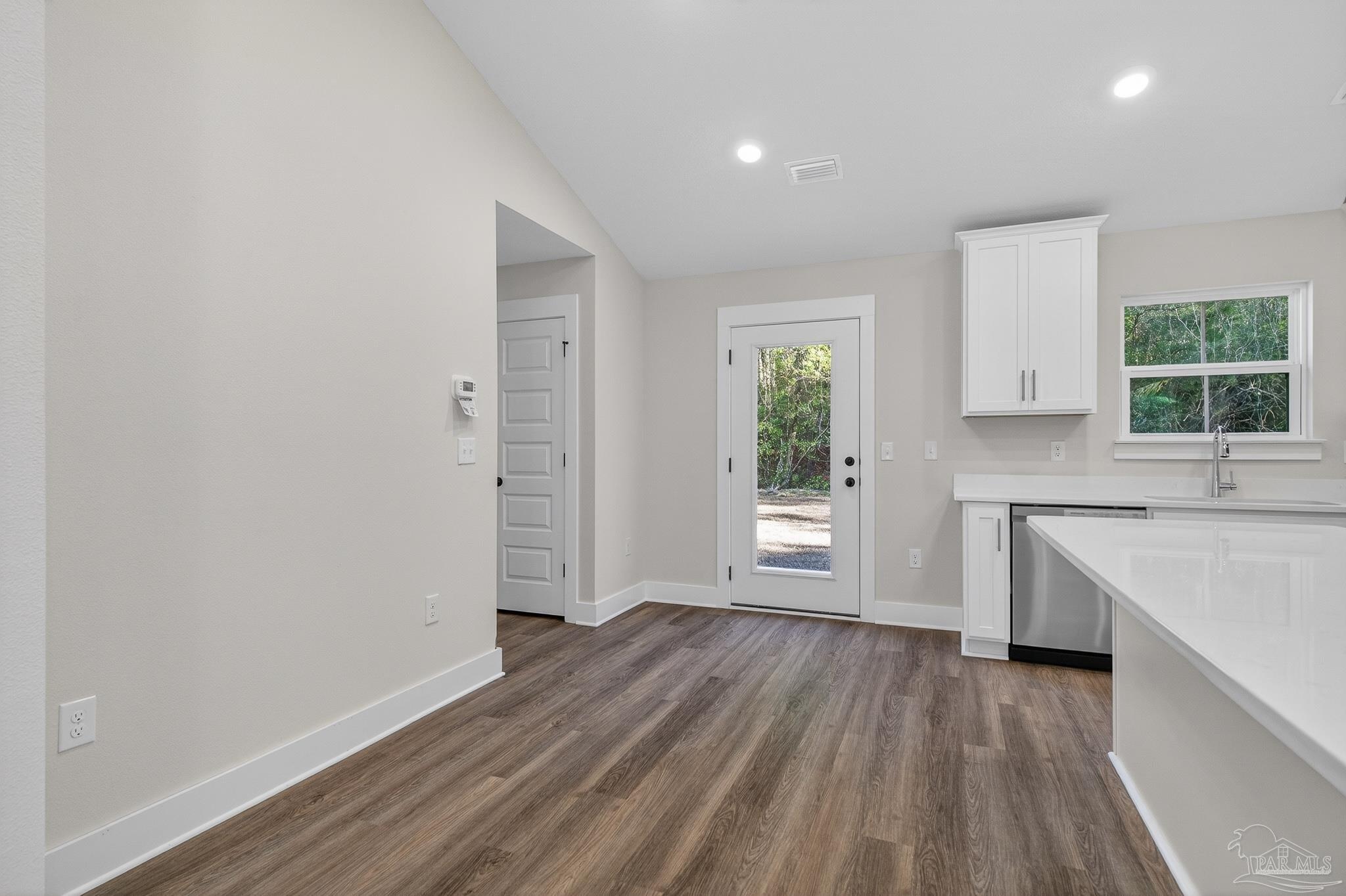 1056 Barth Road Molino, FL 32577 - Photo 19 of 46 an empty room with wooden floor and windows