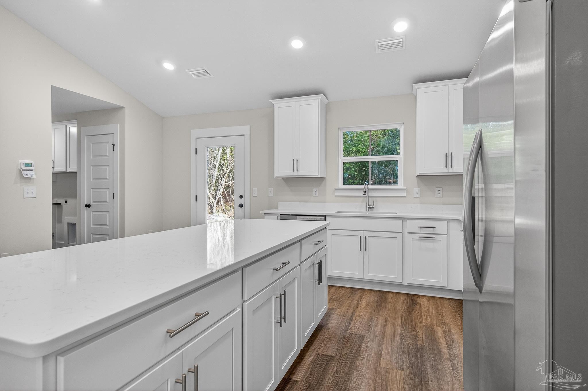 1056 Barth Road Molino, FL 32577 - Photo 20 of 46 a kitchen with a refrigerator and windows