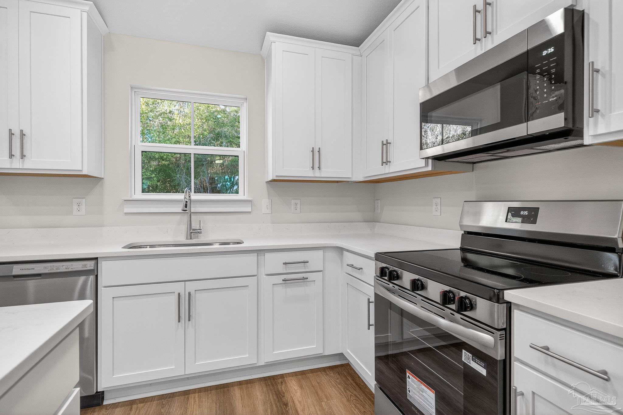 1056 Barth Road Molino, FL 32577 - Photo 2 of 46 a kitchen with granite countertop white cabinets and appliances