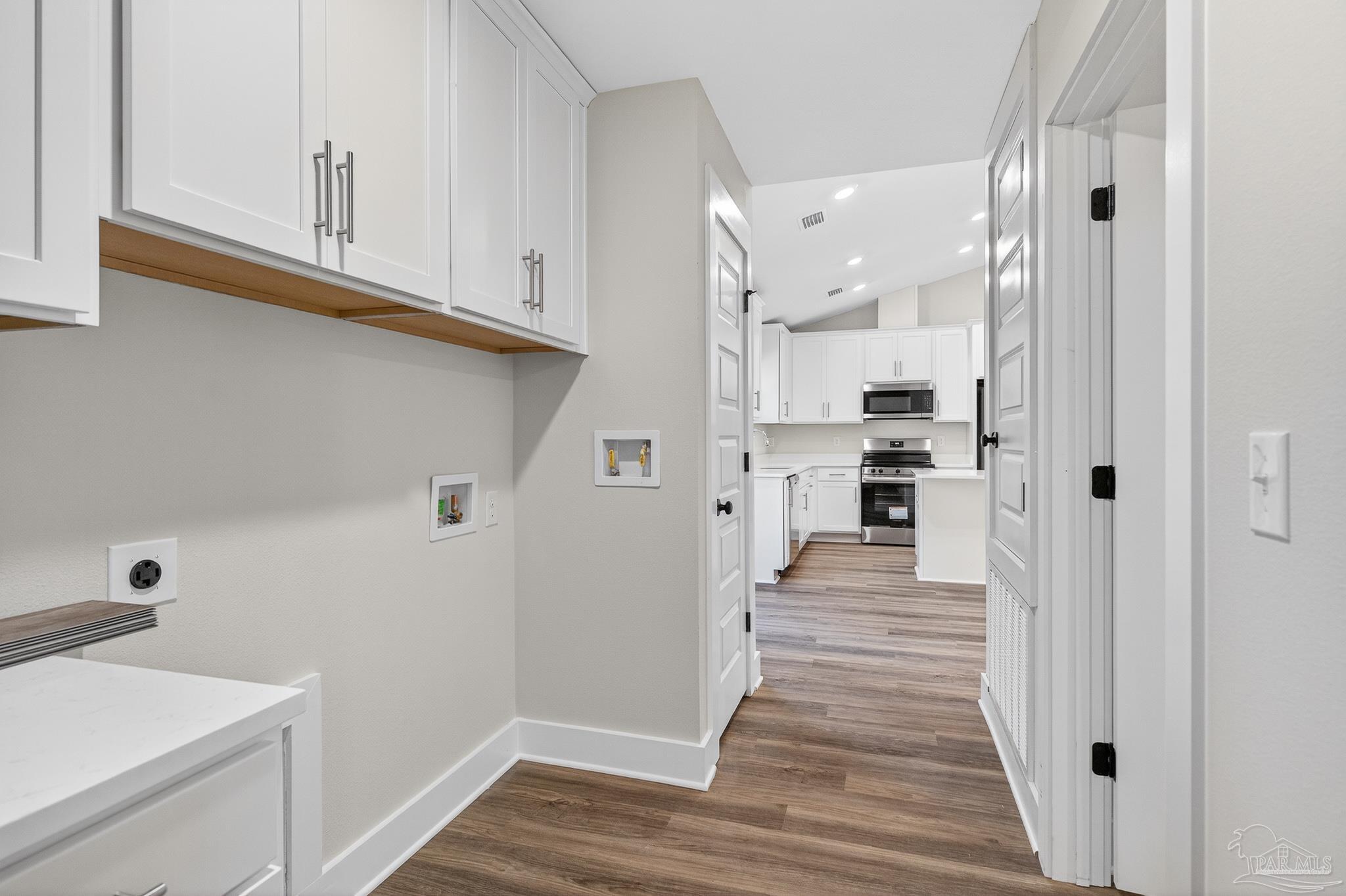 1056 Barth Road Molino, FL 32577 - Photo 25 of 46 a view of a kitchen with wooden floor and electronic appliances