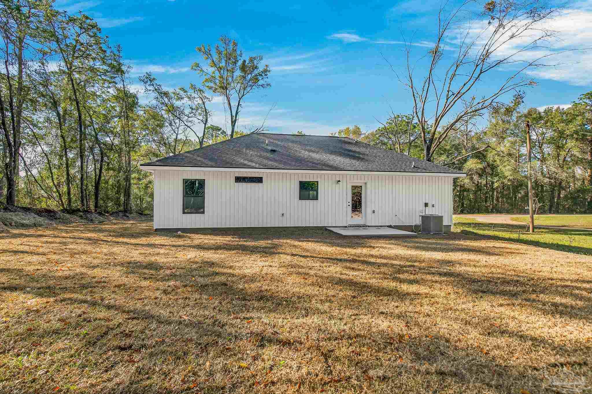 1056 Barth Road Molino, FL 32577 - Photo 29 of 46 a view of a house with a yard and tree