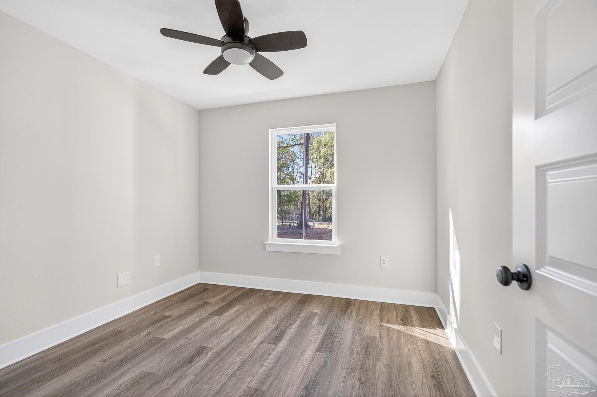 1056 Barth Road Molino, FL 32577 - Photo 30 of 46 wooden floor in an empty room with a window