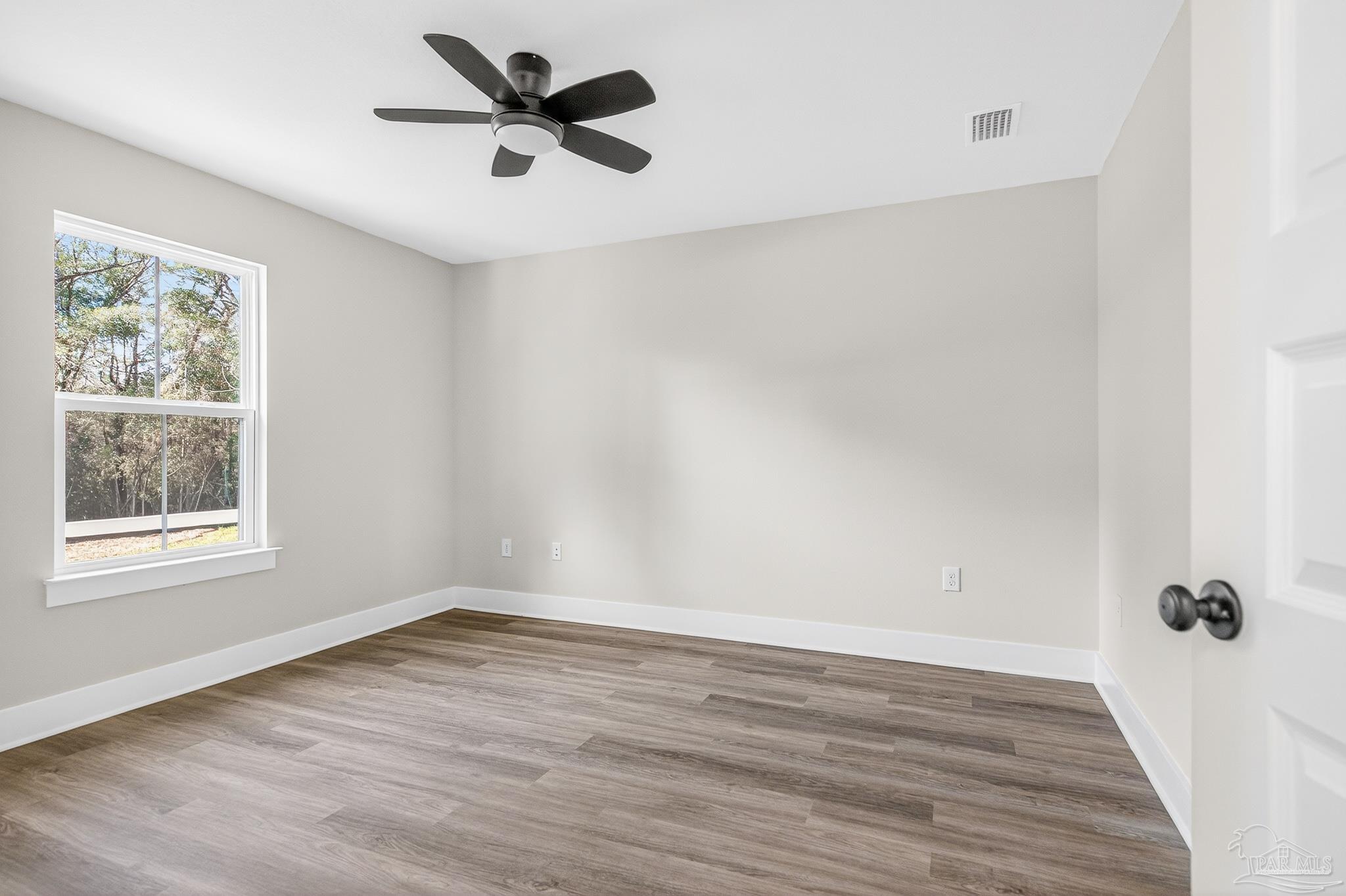 1056 Barth Road Molino, FL 32577 - Photo 35 of 46 wooden floor in an empty room with a window