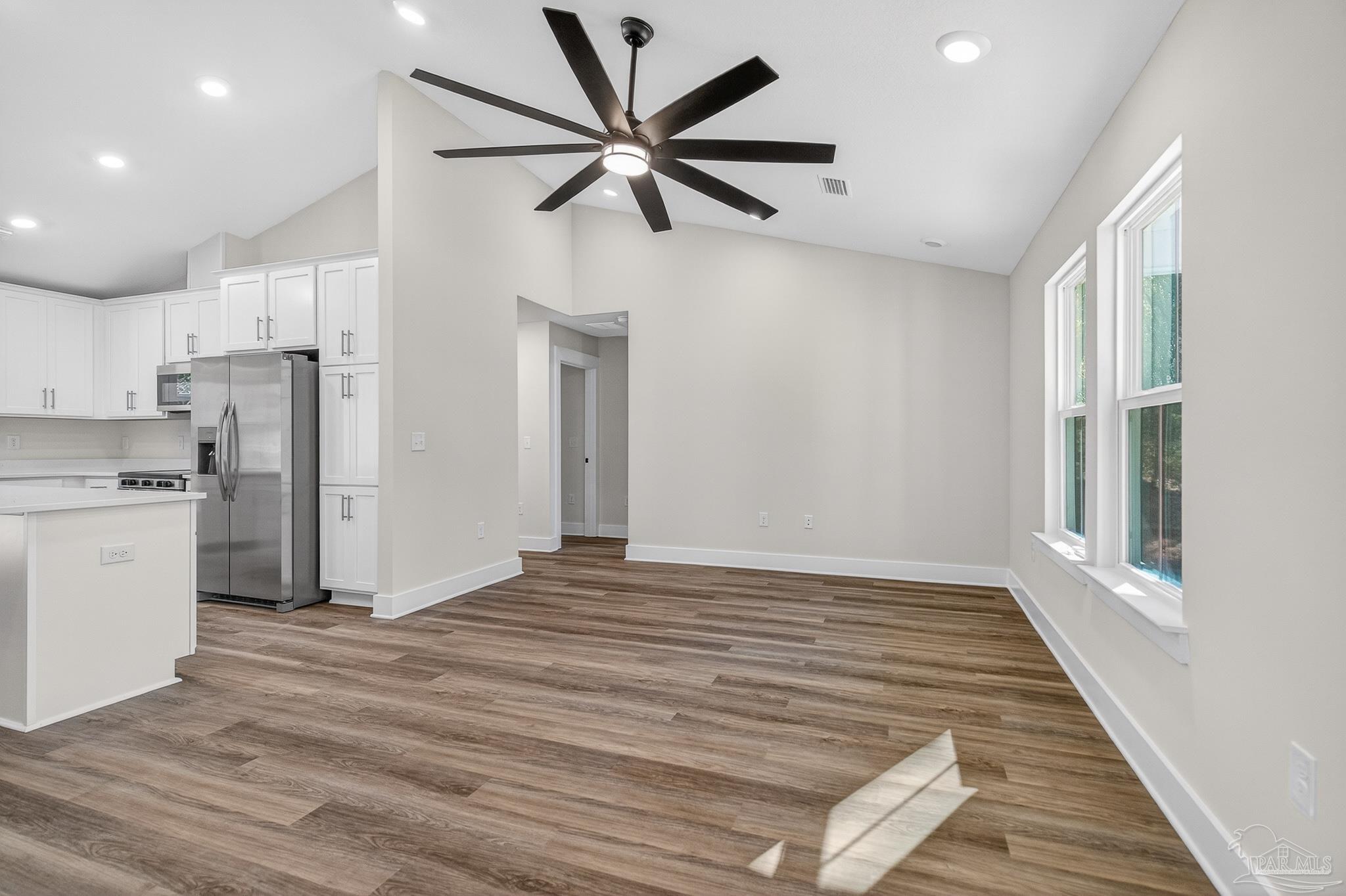 1056 Barth Road Molino, FL 32577 - Photo 38 of 46 a view of empty room with wooden floor and ceiling fan