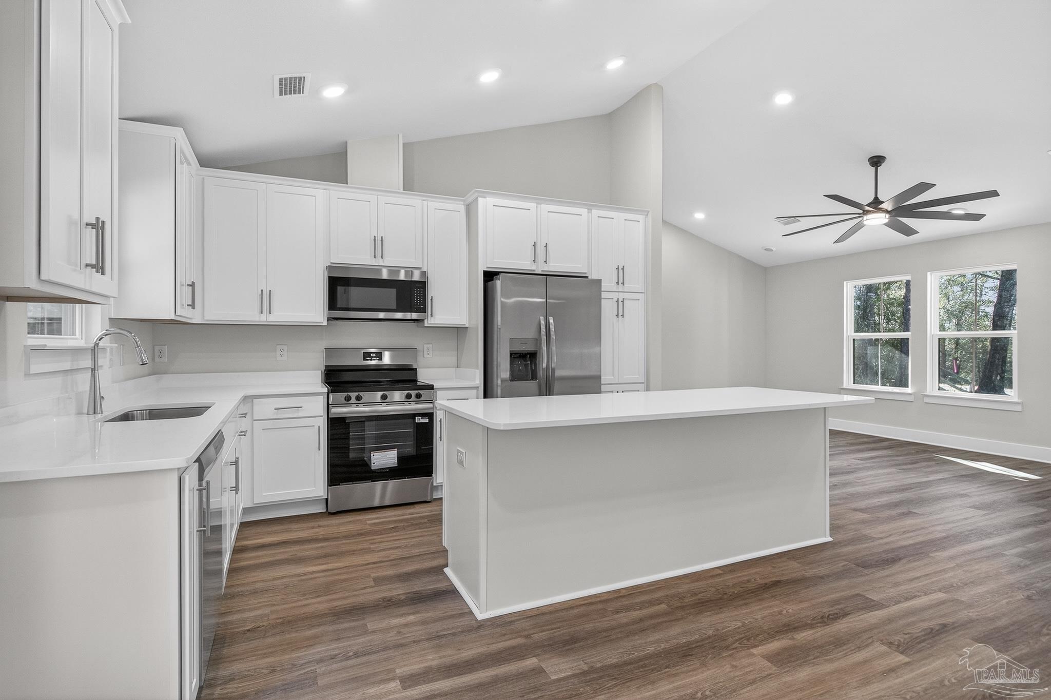 1056 Barth Road Molino, FL 32577 - Photo 39 of 46 a kitchen with stainless steel appliances granite countertop a stove a sink and a refrigerator