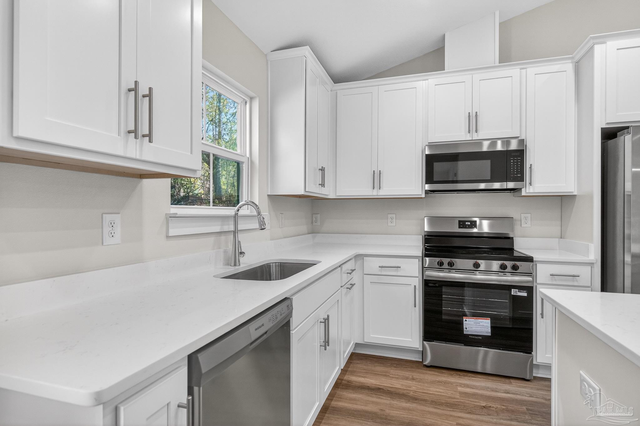 1056 Barth Road Molino, FL 32577 - Photo 4 of 46 a kitchen with appliances a sink and cabinets