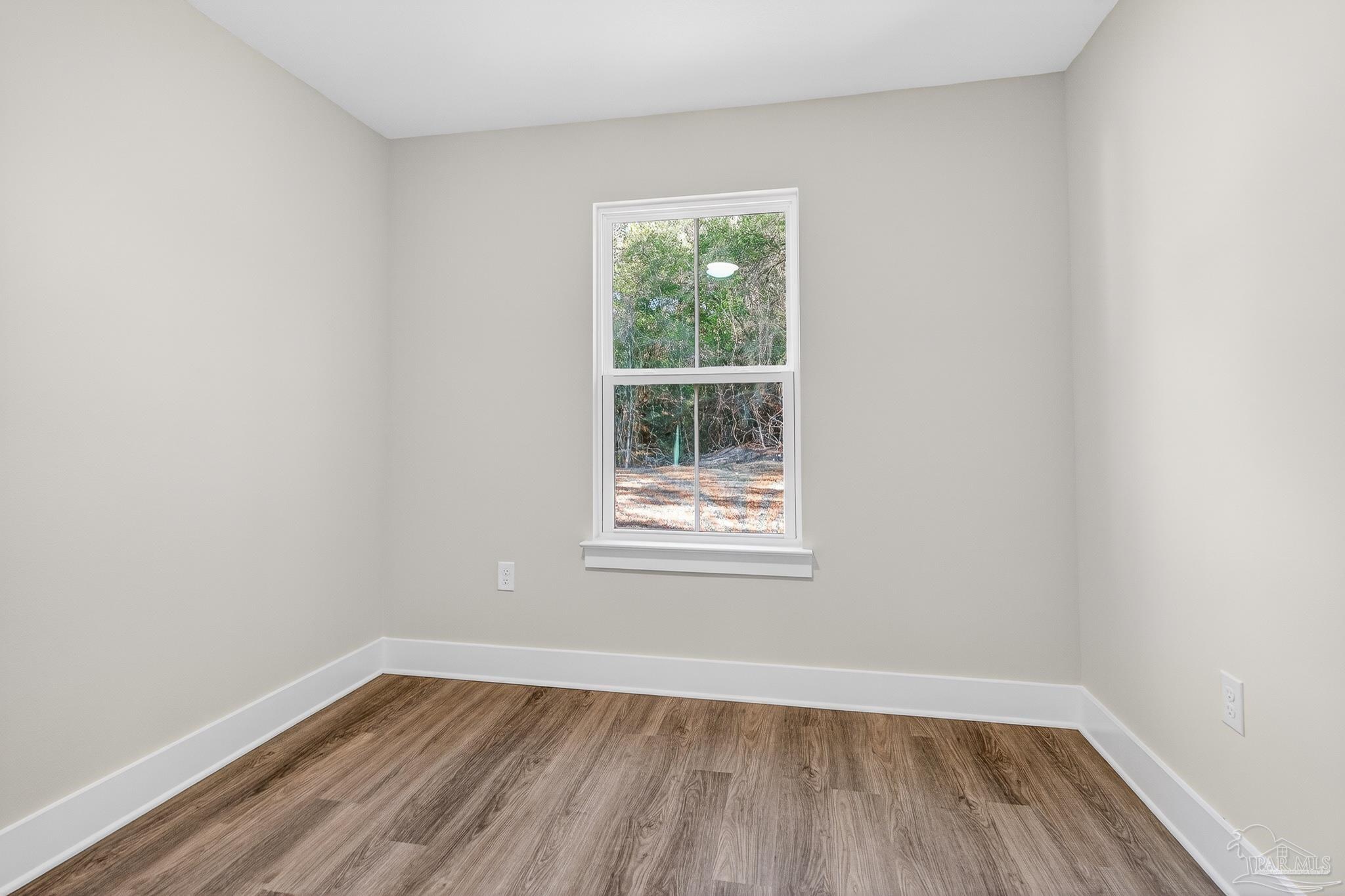 1056 Barth Road Molino, FL 32577 - Photo 44 of 46 an empty room with wooden floor and windows