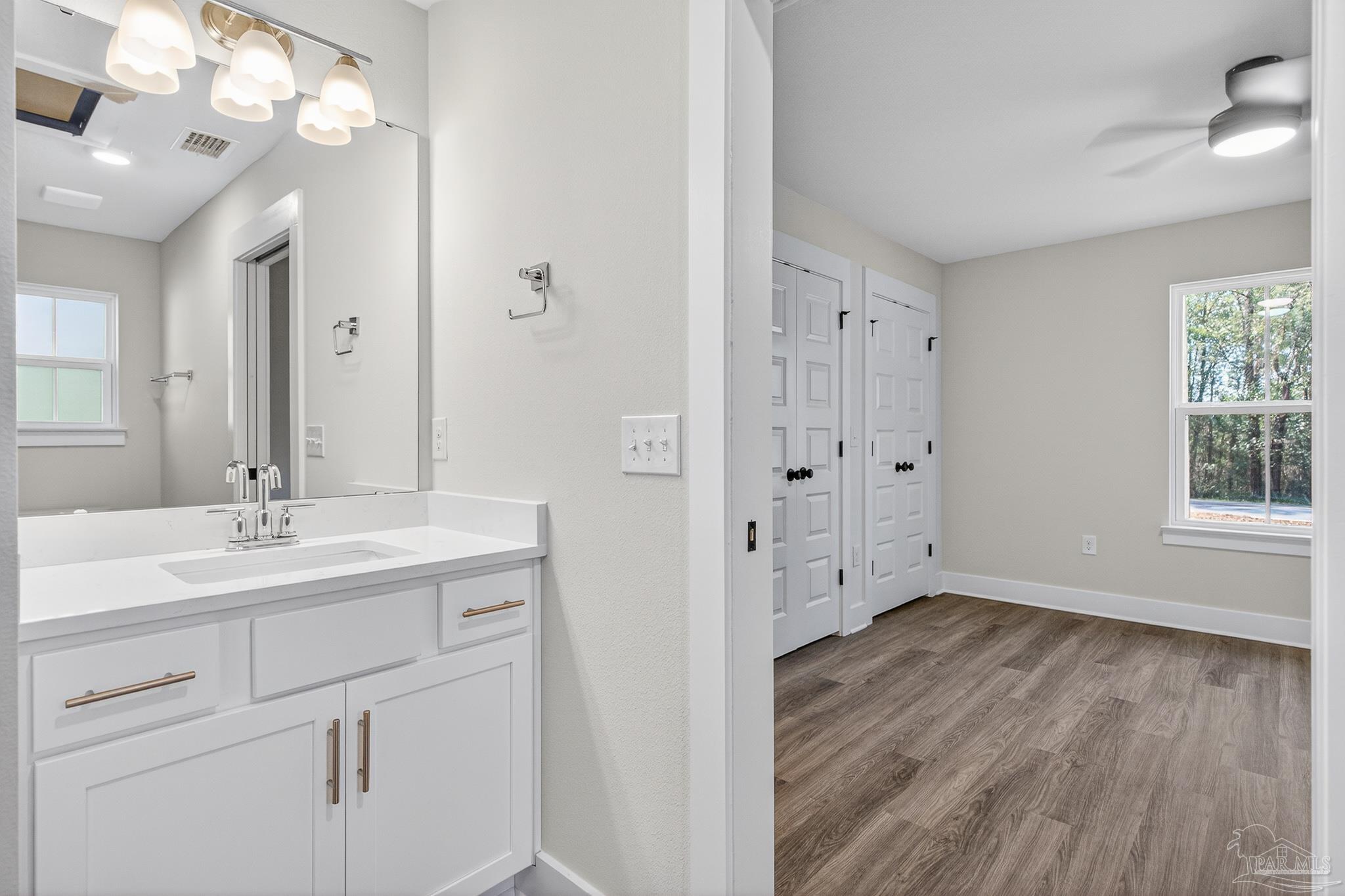 1056 Barth Road Molino, FL 32577 - Photo 6 of 46 a bathroom with a sink a mirror a vanity and a shower