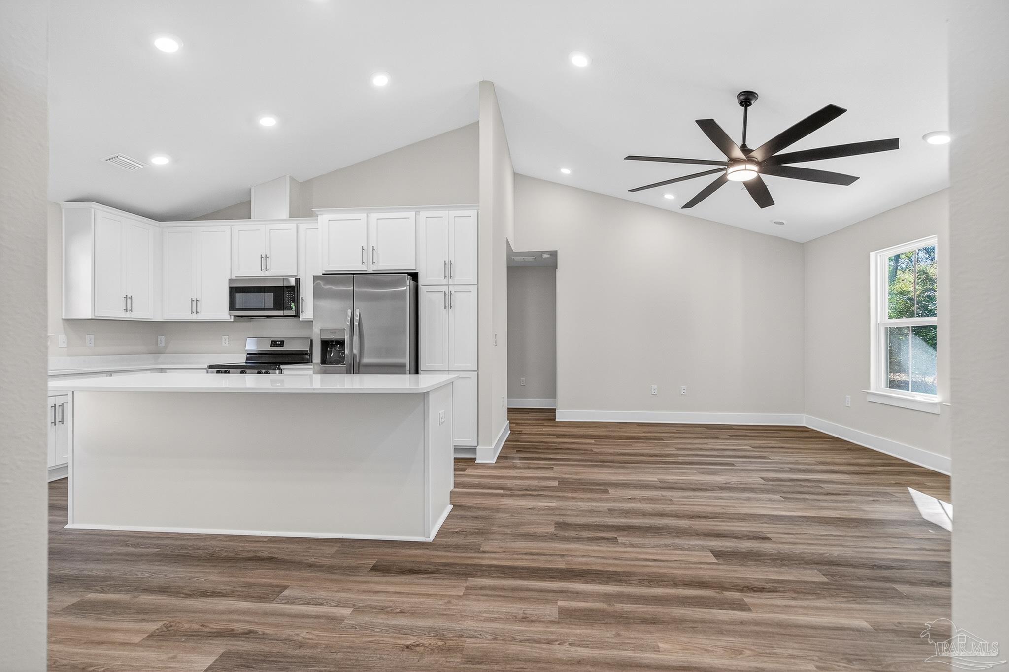 1056 Barth Road Molino, FL 32577 - Photo 7 of 46 a view of kitchen with stainless steel appliances granite countertop a stove a sink and white cabinets with wooden floors