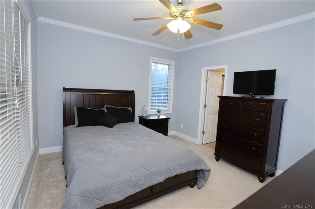 9805 Vineyard Road Mount Pleasant, NC 28124 - Photo 13 of 24 a bedroom with a bed and a flat screen tv