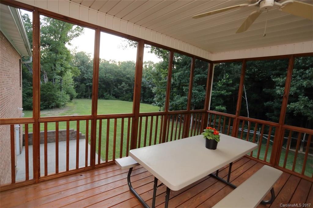 9805 Vineyard Road Mount Pleasant, NC 28124 - Photo 22 of 24 a view of a dining table and chairs on the roof deck