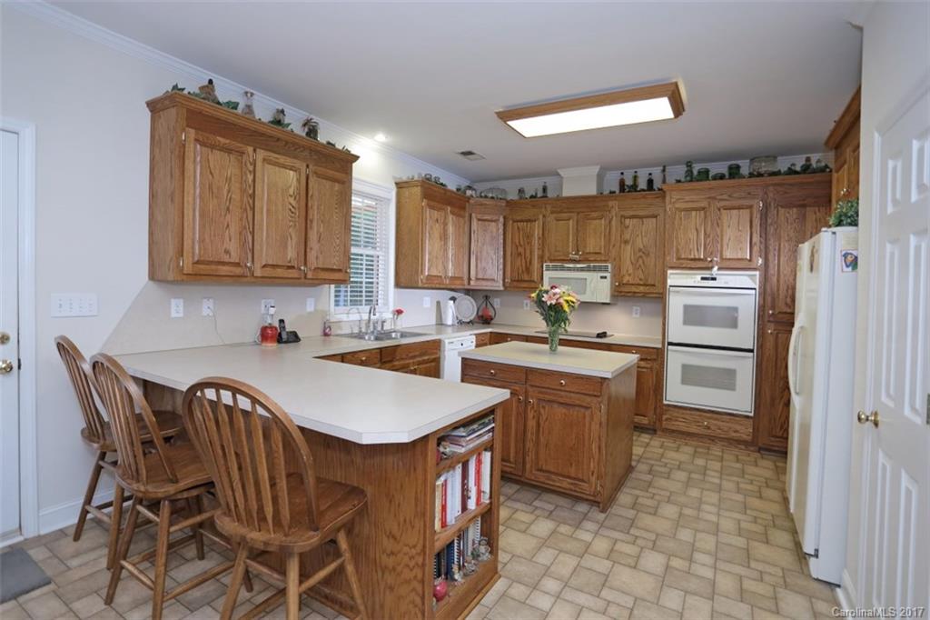 9805 Vineyard Road Mount Pleasant, NC 28124 - Photo 7 of 24 a kitchen with a sink appliances and cabinets