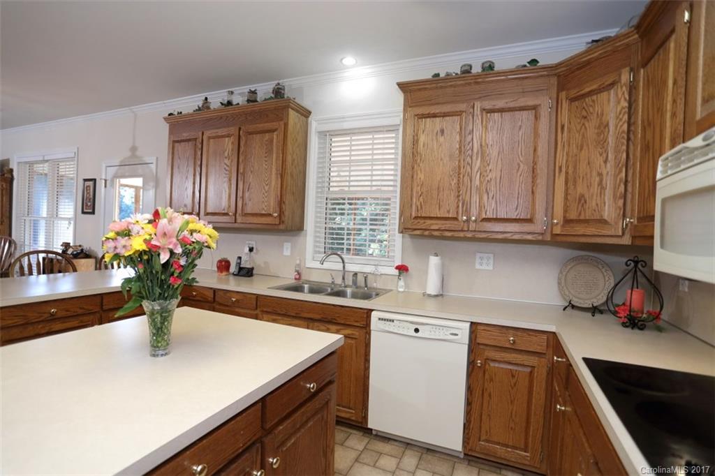 9805 Vineyard Road Mount Pleasant, NC 28124 - Photo 8 of 24 a kitchen with a sink dishwasher and a stove with wooden floor