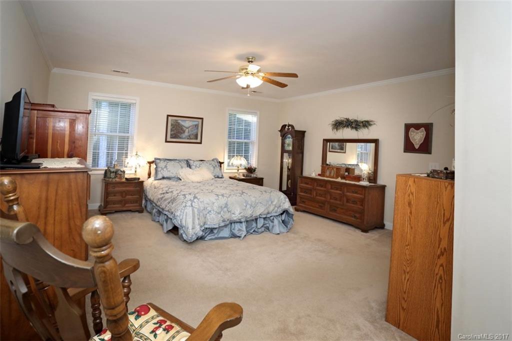 9805 Vineyard Road Mount Pleasant, NC 28124 - Photo 9 of 24 a bedroom with a bed dresser and a flat screen tv