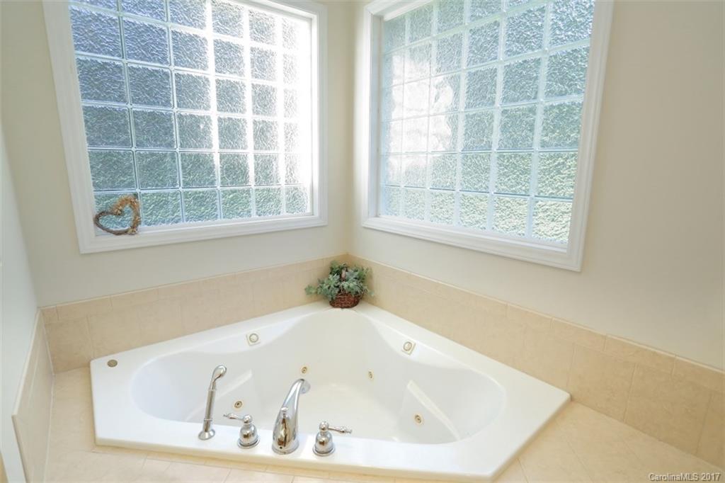 9805 Vineyard Road Mount Pleasant, NC 28124 - Photo 10 of 24 a white bath tub sitting in a bathroom next to a window