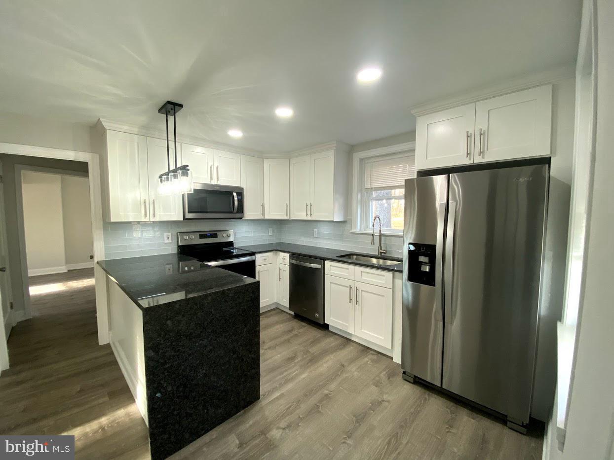 2817 Egypt Road Audubon, PA 19403 - Photo 9 of 25 a kitchen with granite countertop stainless steel appliances and wooden cabinets