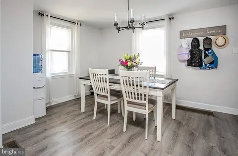 a dining room with wooden floor and breakfast area