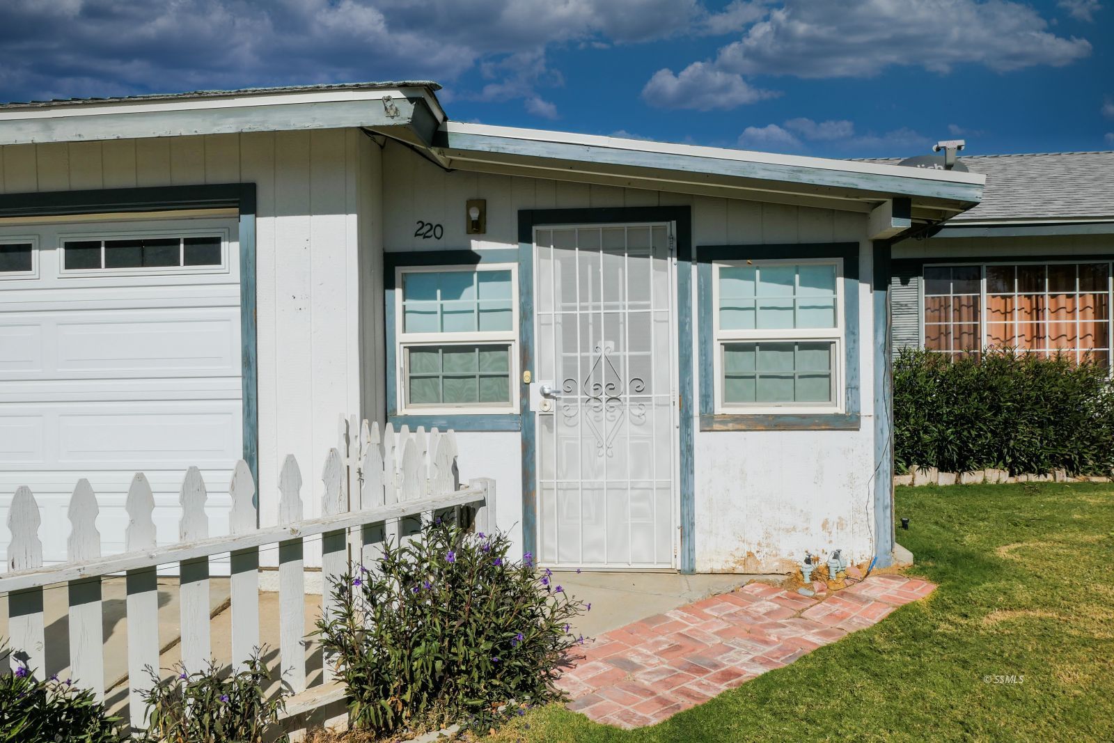 220 West Benson Avenue Ridgecrest, CA 93555 - Photo 2 of 38 a front view of a house with a garden