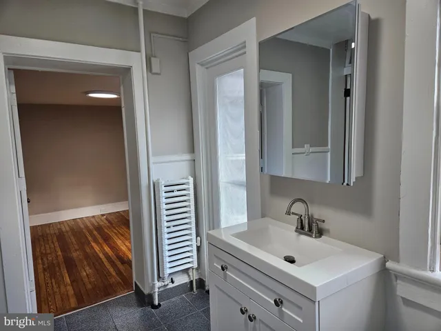 a white toilet and tub sitting next to a bathroom sink