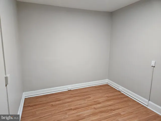 an empty room with wooden floor