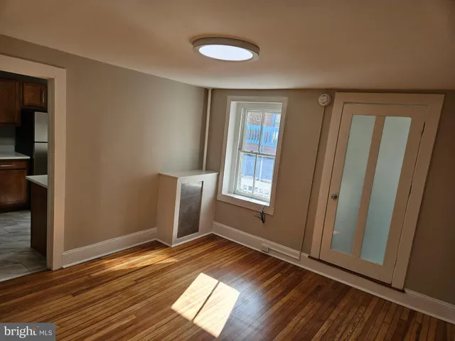 a view of a room with wooden floor and staircase