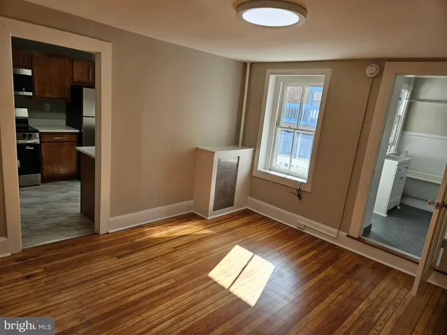 a view of a room with wooden floor