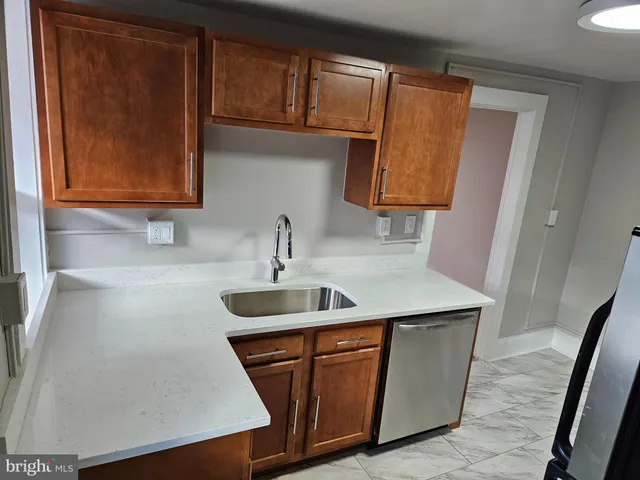 a kitchen with a sink and a stove top oven