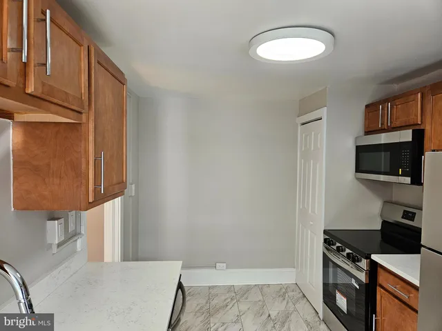 a kitchen with stainless steel appliances granite countertop a sink and a wooden cabinets