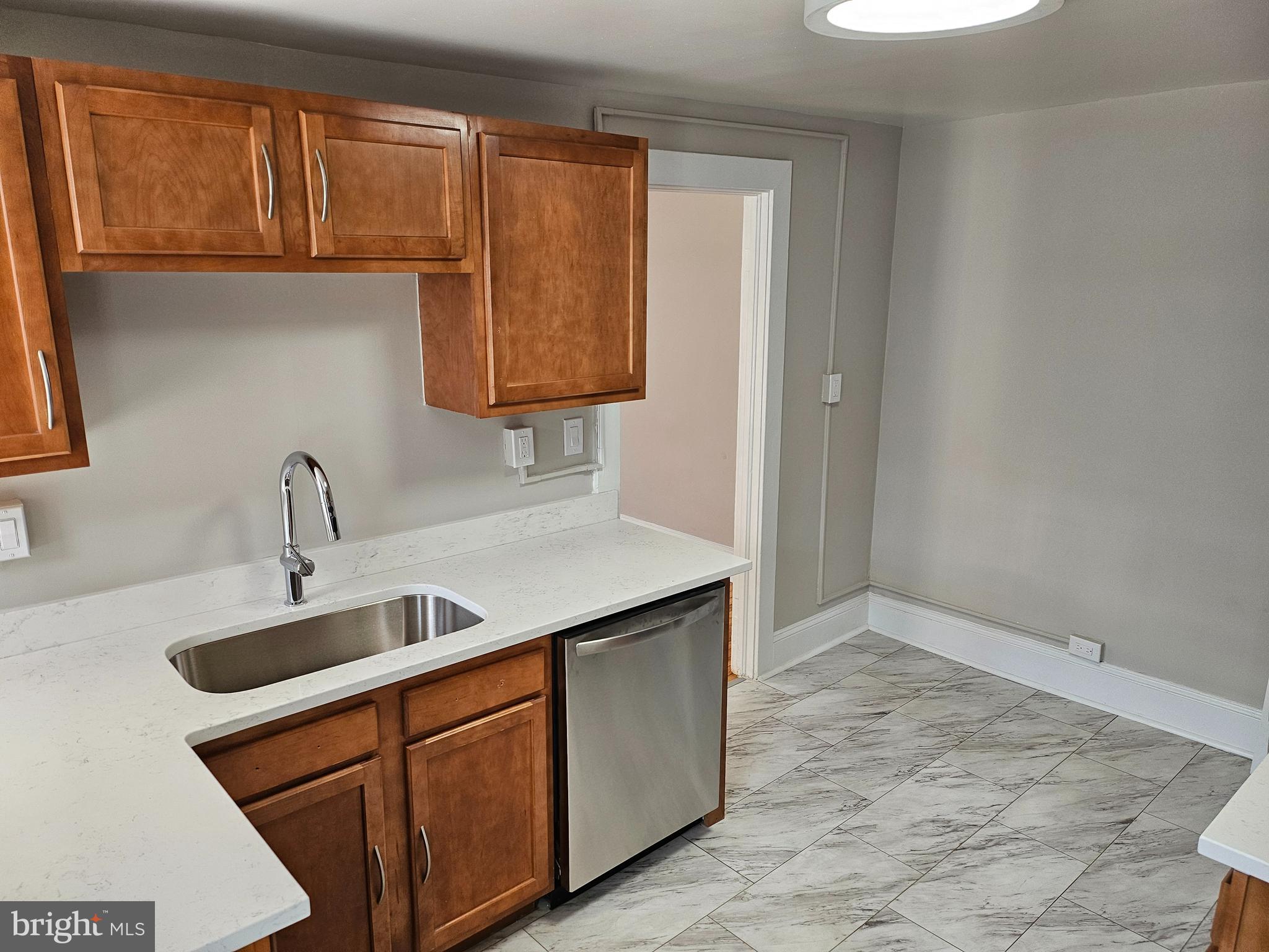 334 North Market Street, Unit 2 Frederick, MD 21701 - Photo 10 of 28 a kitchen with stainless steel appliances granite countertop a sink and a wooden cabinets