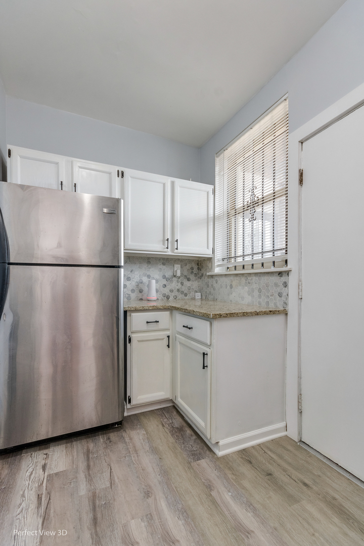 2212 East 70th Street, Unit 3D Chicago, IL 60649 - Photo 11 of 21 a white refrigerator freezer sitting inside of a kitchen