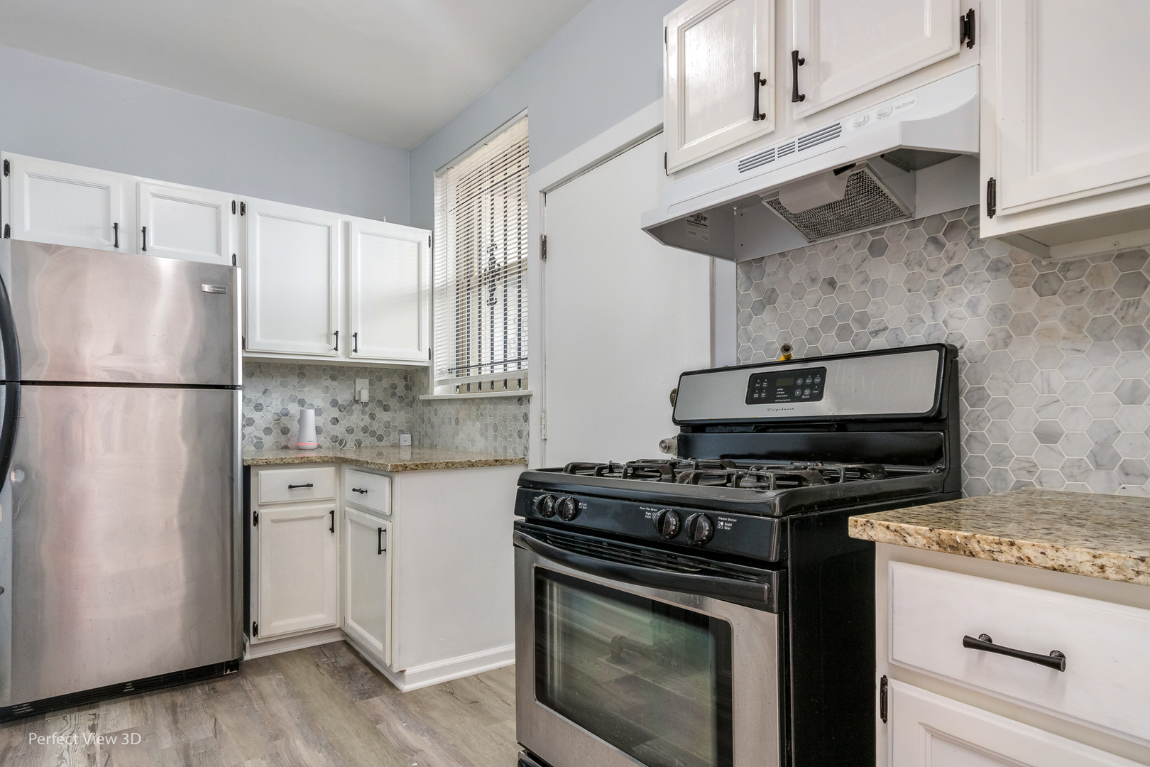 2212 East 70th Street, Unit 3D Chicago, IL 60649 - Photo 13 of 21 a kitchen with stainless steel appliances a stove a sink and a refrigerator