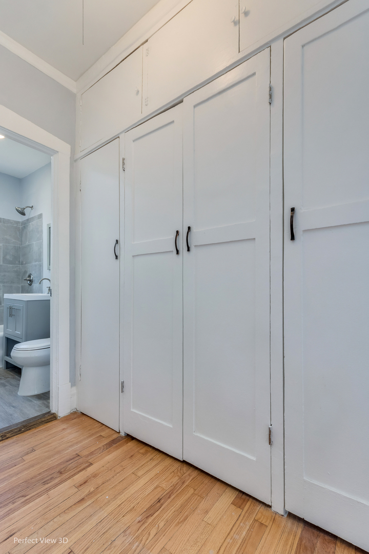2212 East 70th Street, Unit 3D Chicago, IL 60649 - Photo 15 of 21 a view of an empty room with wooden floor and a window