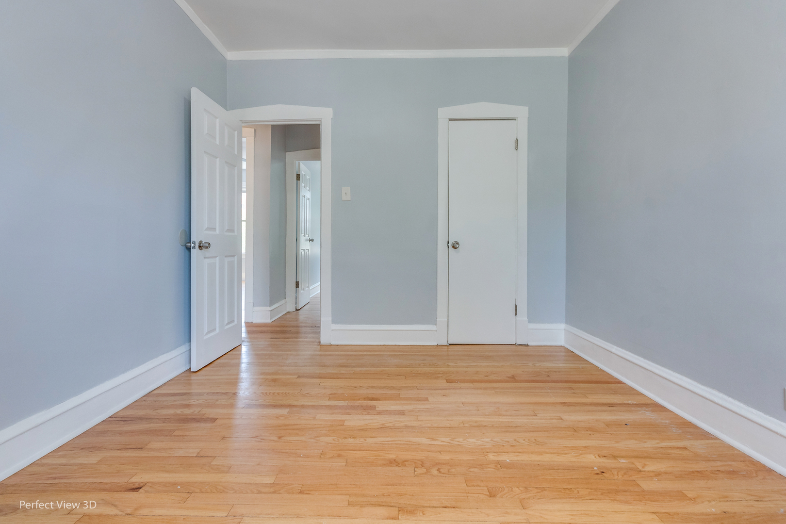 2212 East 70th Street, Unit 3D Chicago, IL 60649 - Photo 18 of 21 a view of an empty room with wooden floor and closet