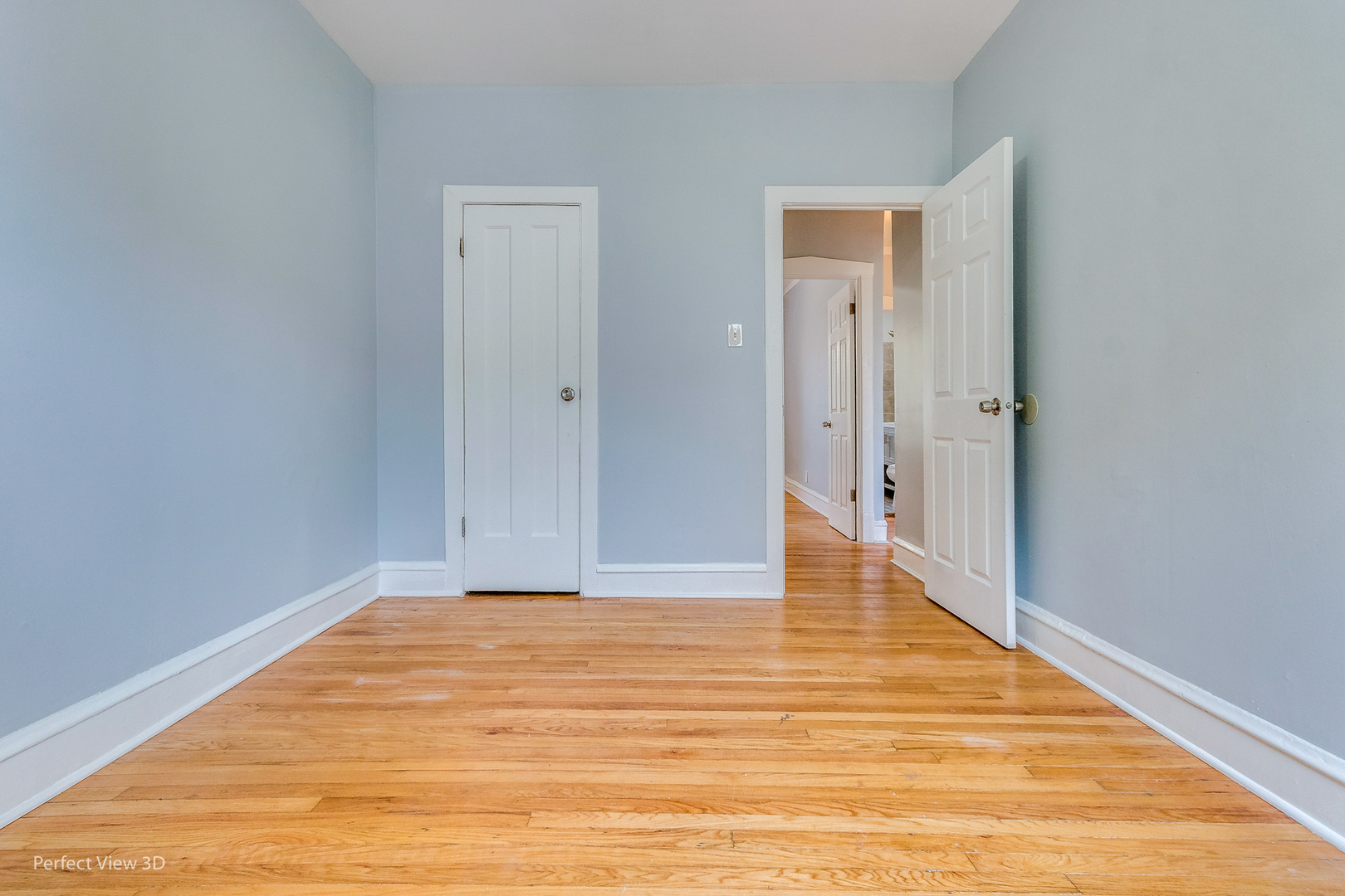 2212 East 70th Street, Unit 3D Chicago, IL 60649 - Photo 20 of 21 a view of an empty room with wooden floor