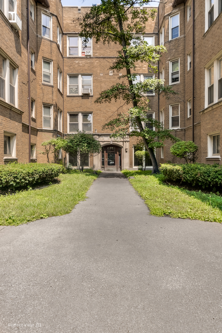 2212 East 70th Street, Unit 3D Chicago, IL 60649 - Photo 2 of 21 a view of a building with a yard