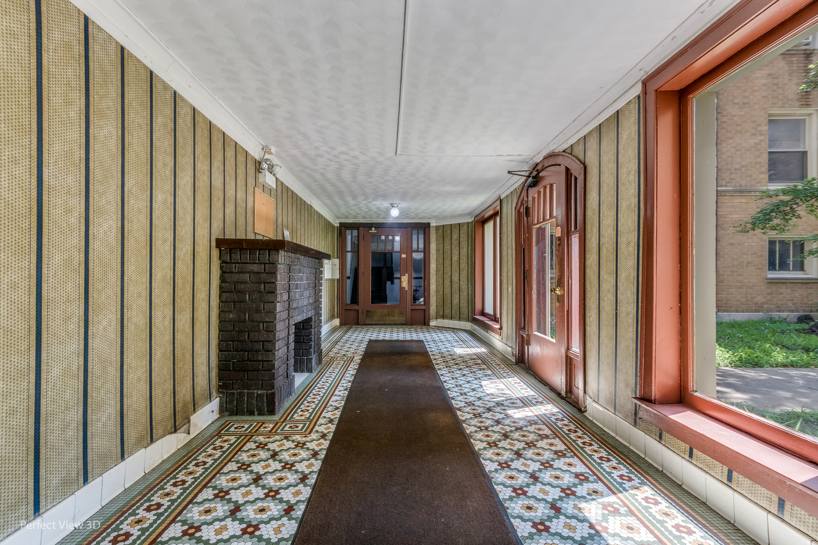 2212 East 70th Street, Unit 3D Chicago, IL 60649 - Photo 5 of 21 a view of a hallway with wooden floor and staircase