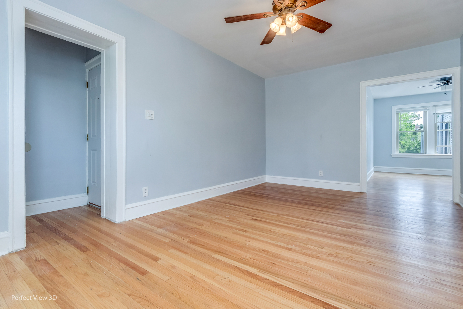 2212 East 70th Street, Unit 3D Chicago, IL 60649 - Photo 6 of 21 wooden floor in an empty room with a window
