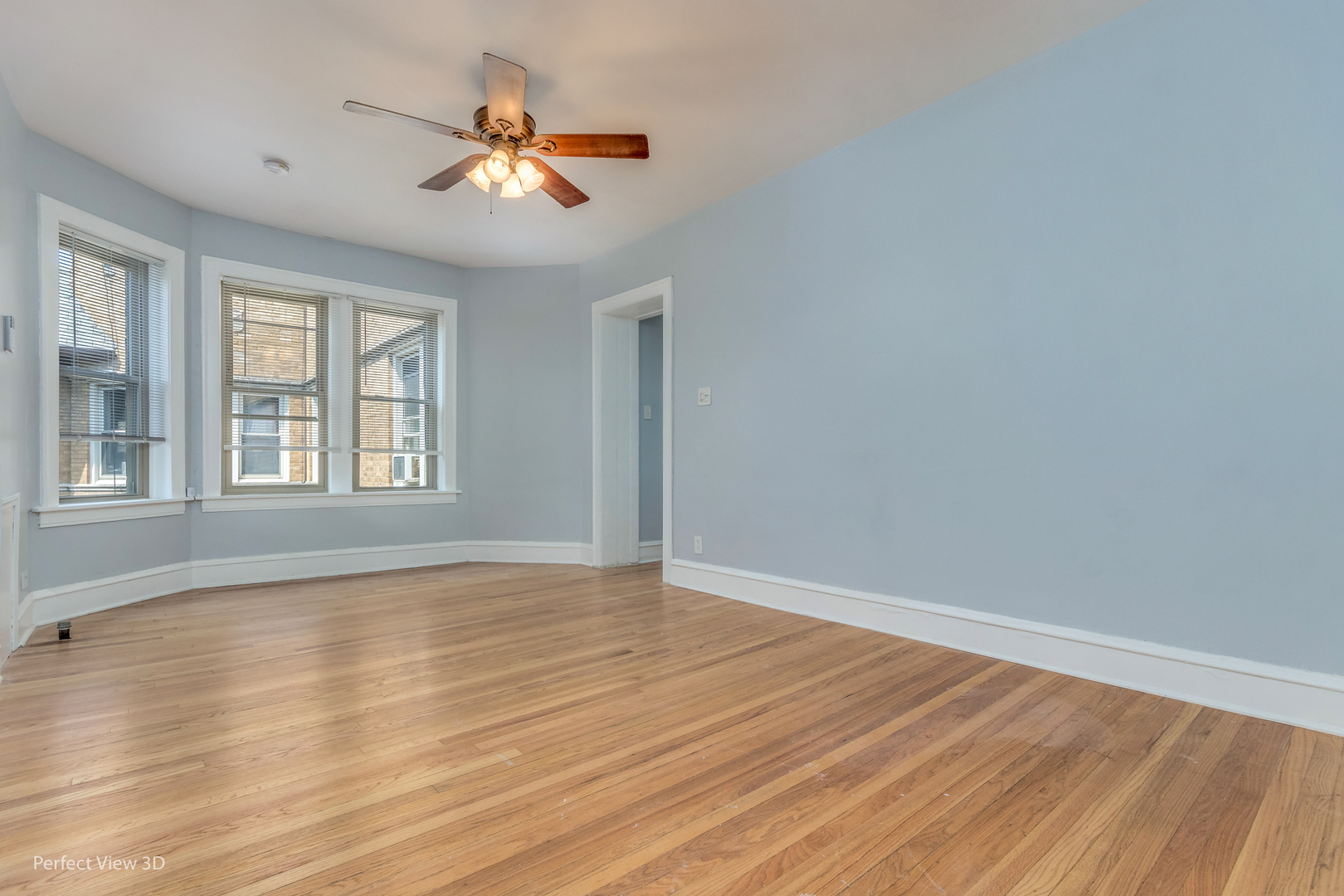 2212 East 70th Street, Unit 3D Chicago, IL 60649 - Photo 7 of 21 a view of an empty room with wooden floor and a window