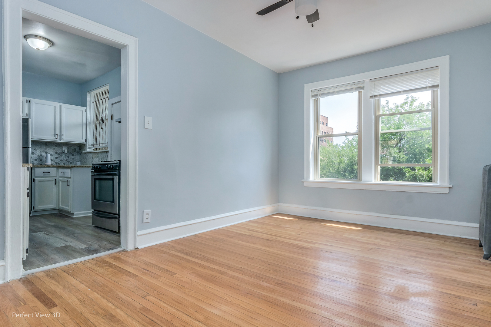 2212 East 70th Street, Unit 3D Chicago, IL 60649 - Photo 9 of 21 an empty room with wooden floor and a window