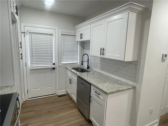 a kitchen with a sink and cabinets