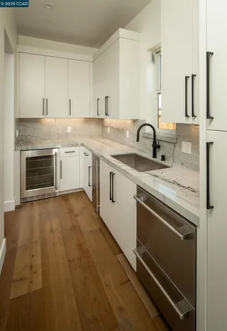 a view of a kitchen with sink stove and cabinets